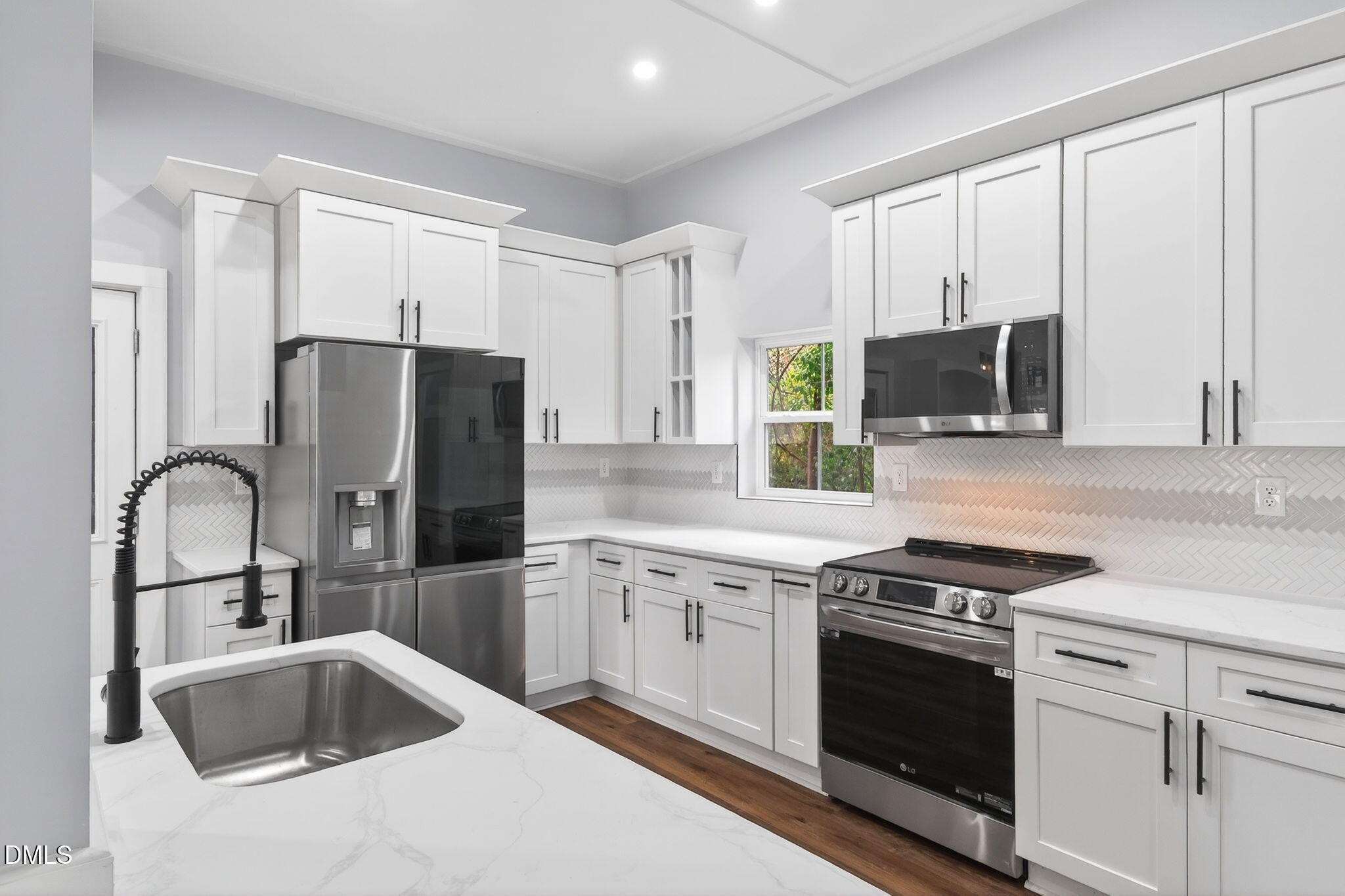 221 East Lee Street Raleigh, NC 27601 - Photo 15 of 41 a kitchen with stainless steel appliances granite countertop a sink stove and refrigerator