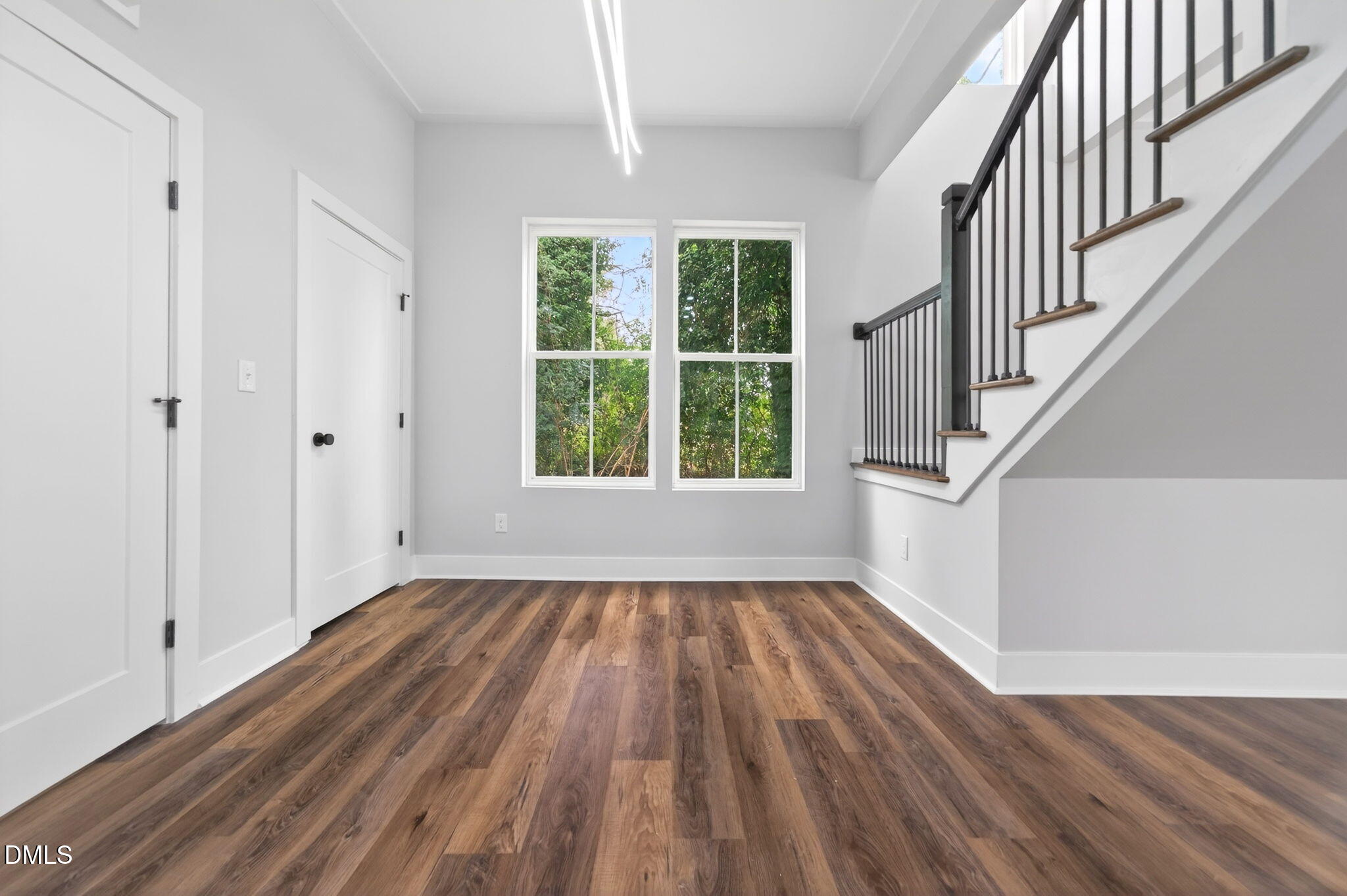 221 East Lee Street Raleigh, NC 27601 - Photo 21 of 41 a view of an empty room with wooden floor and a window