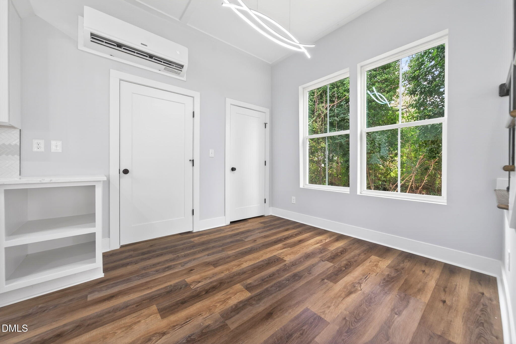 221 East Lee Street Raleigh, NC 27601 - Photo 22 of 41 a view of an empty room with wooden floor and a window