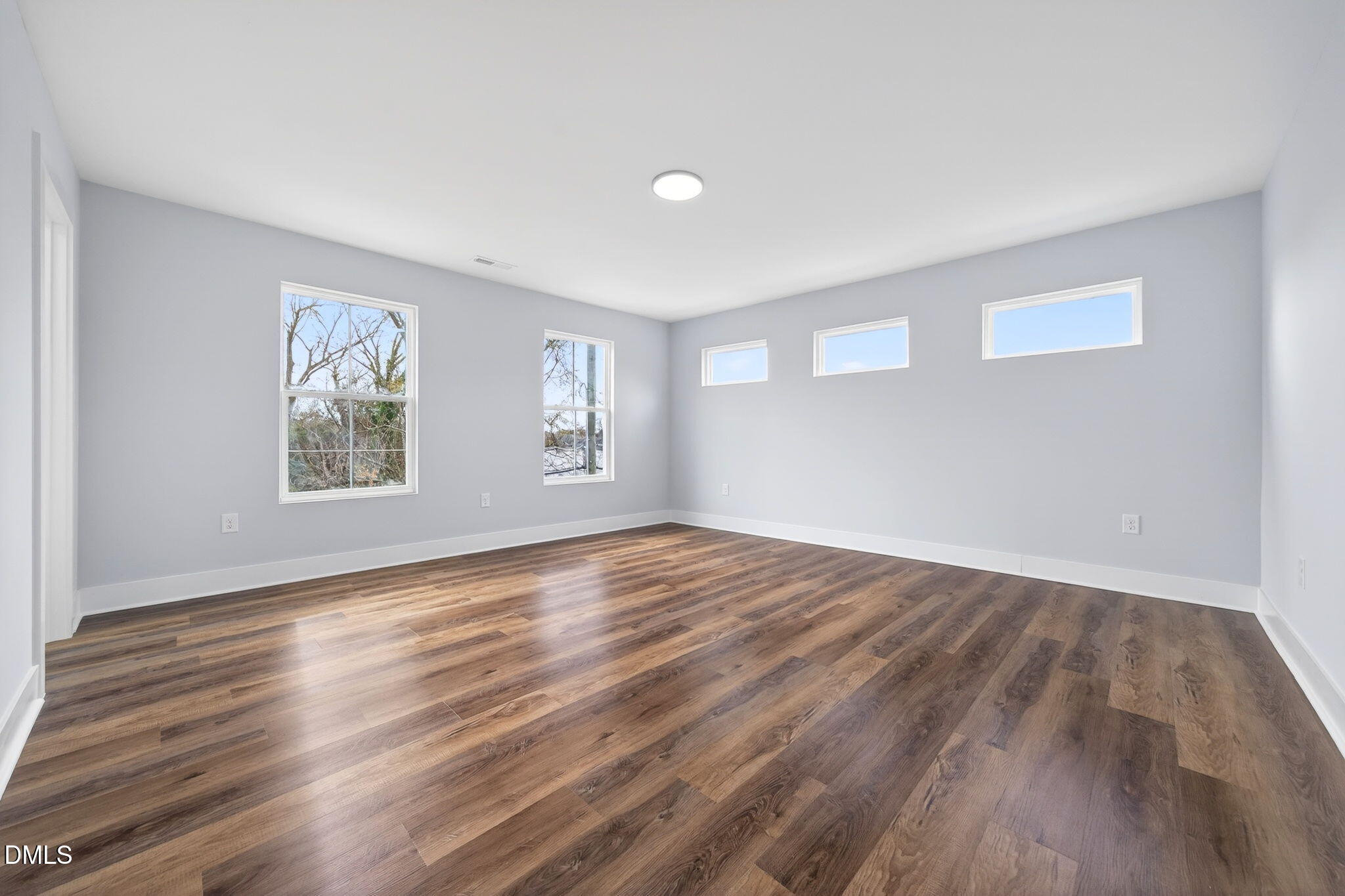 221 East Lee Street Raleigh, NC 27601 - Photo 28 of 41 a view of empty room with wooden floor and fan