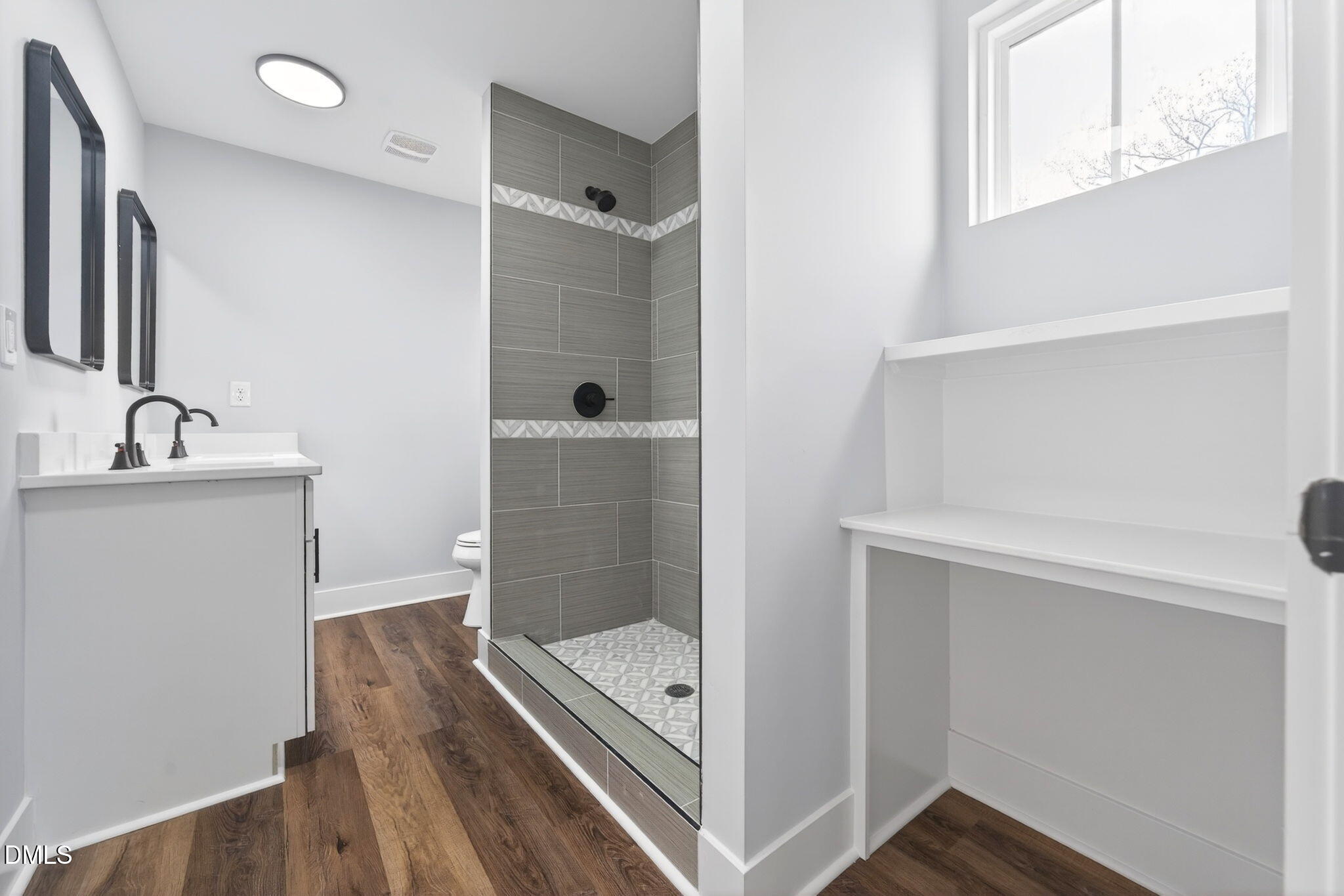 221 East Lee Street Raleigh, NC 27601 - Photo 30 of 41 a bathroom with a tub shower vanity and a sink