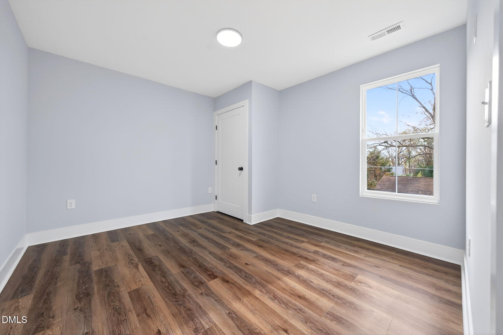 221 East Lee Street Raleigh, NC 27601 - Photo 34 of 41 a view of an empty room with wooden floor and a window