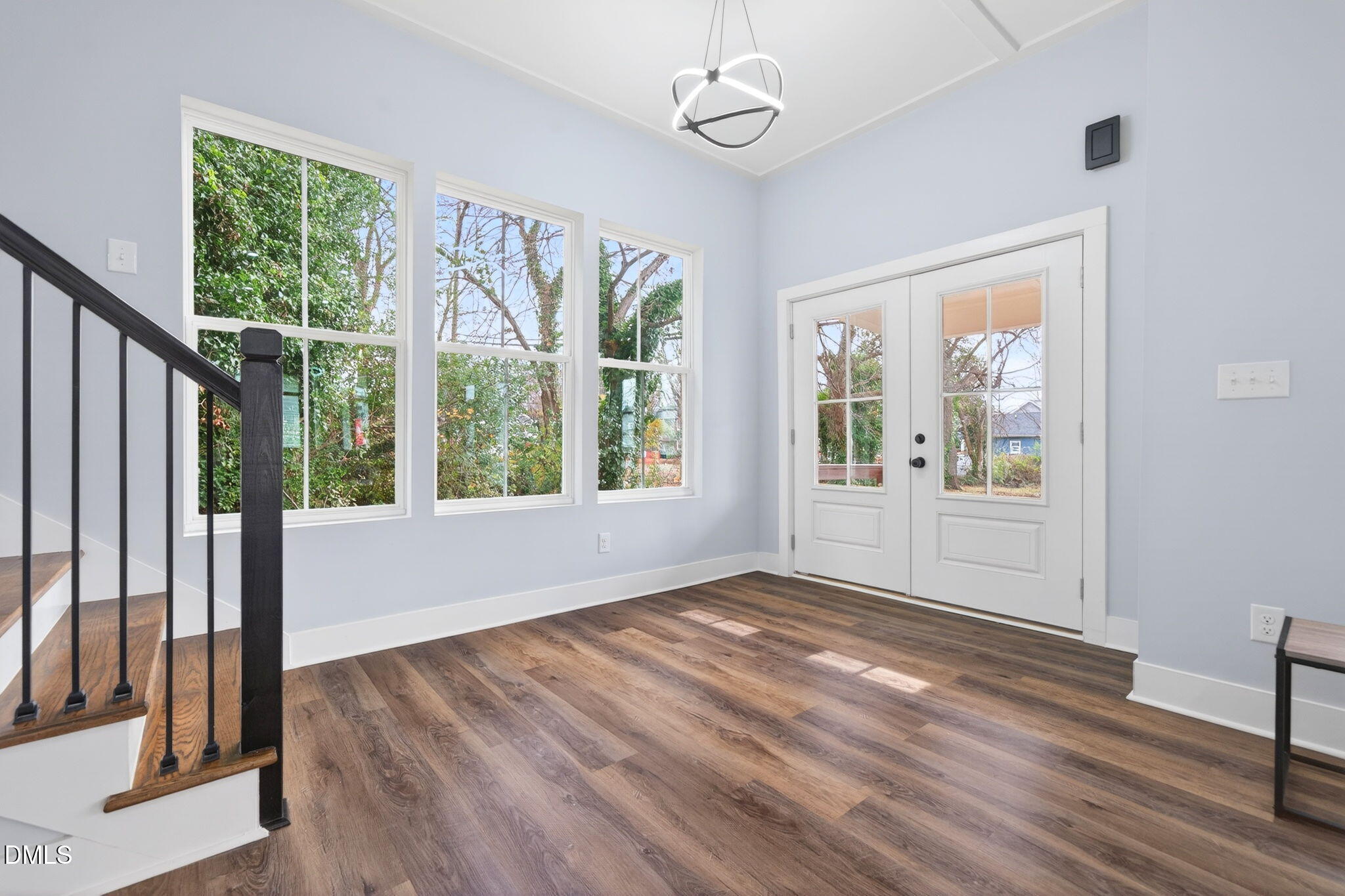221 East Lee Street Raleigh, NC 27601 - Photo 4 of 41 a view of an empty room with wooden floor and a window