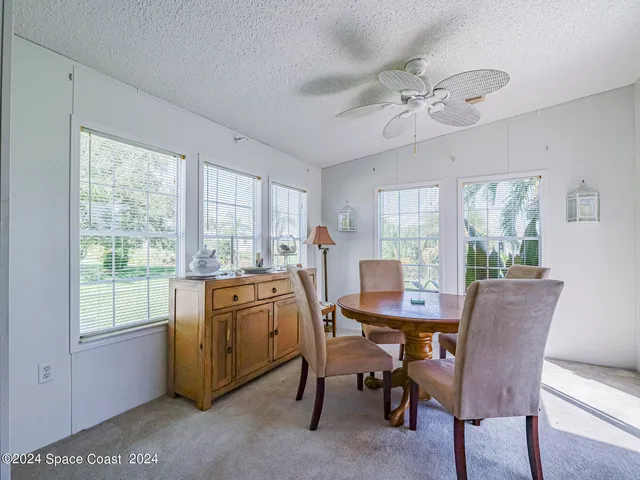 a view of a dining room with furniture window and outside view