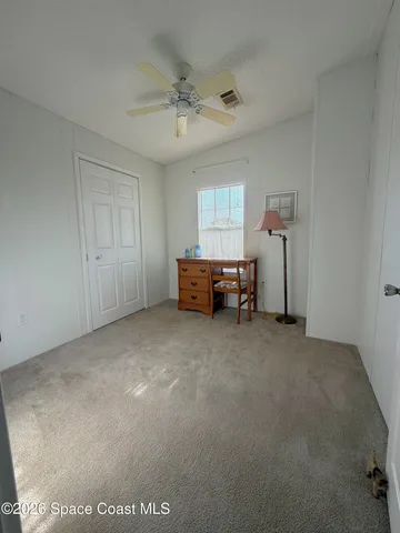 a view of a room with furniture and window