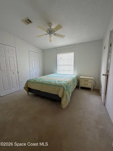 a spacious bedroom with a bed and a window