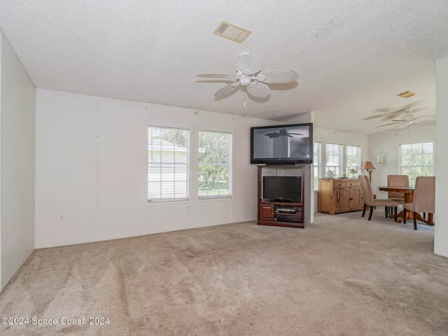 a view of livingroom with furniture fireplace and window