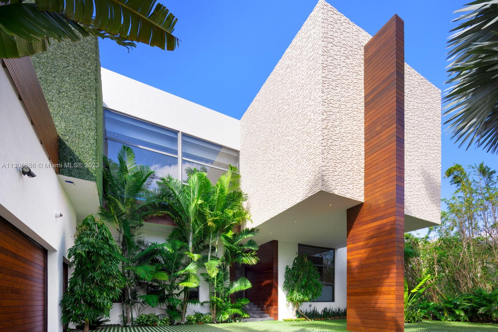 a view of a house with a palm tree