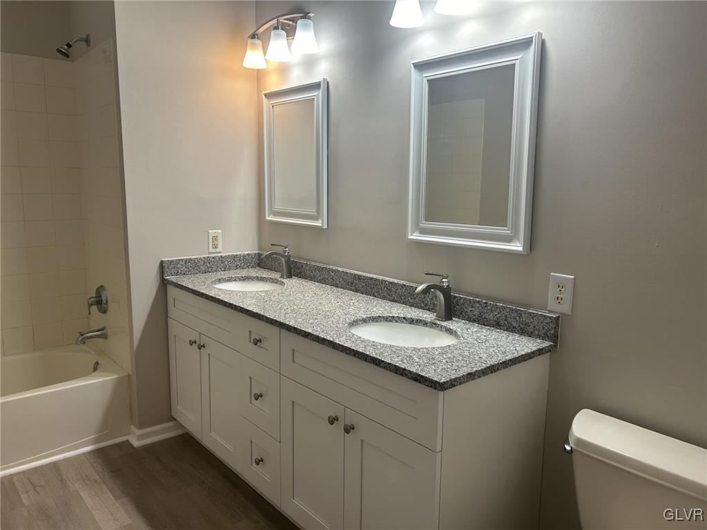 4302 Creek Road Allentown, PA 18104 - Photo 13 of 18 a bathroom with a granite countertop sink and a bathtub