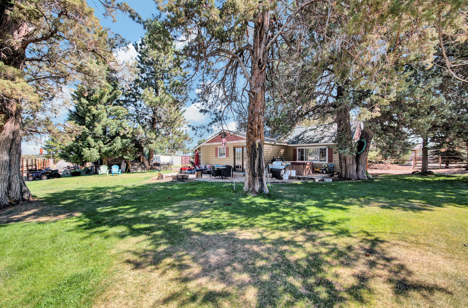 67100 Fryrear Road Bend, OR 97703 - Photo 7 of 38 a front view of a house with a garden and trees
