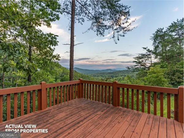 a balcony with wooden floor and fence