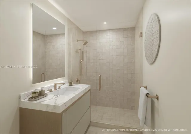 a bathroom with a sink mirror and shower