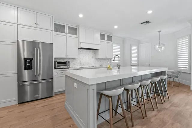 a kitchen with stainless steel appliances granite countertop sink stove and wooden floor
