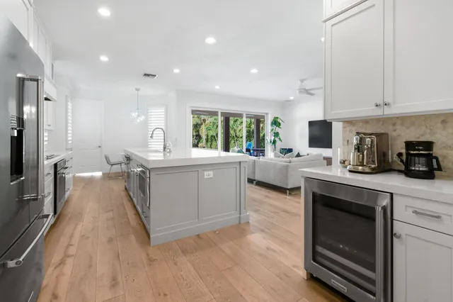 a kitchen with a sink cabinets and wooden floor