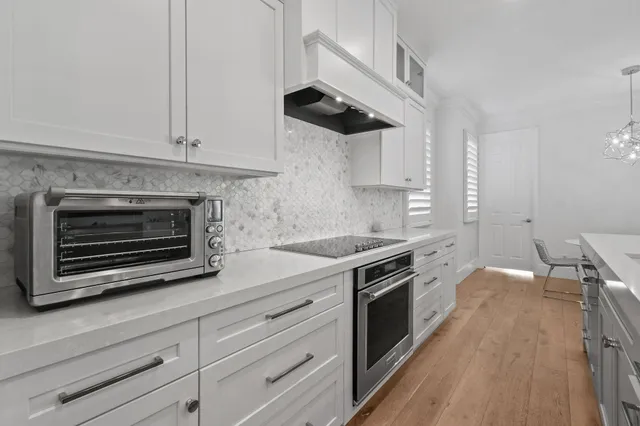 a large kitchen with stainless steel appliances lots of counter space sink and cabinets