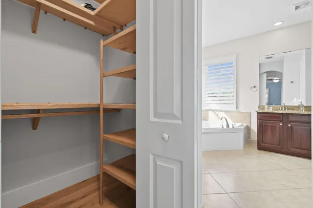 a view of a patio with a table and chairs under an umbrella