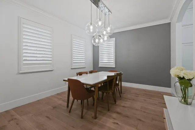 a view of a dining room with furniture and chandelier