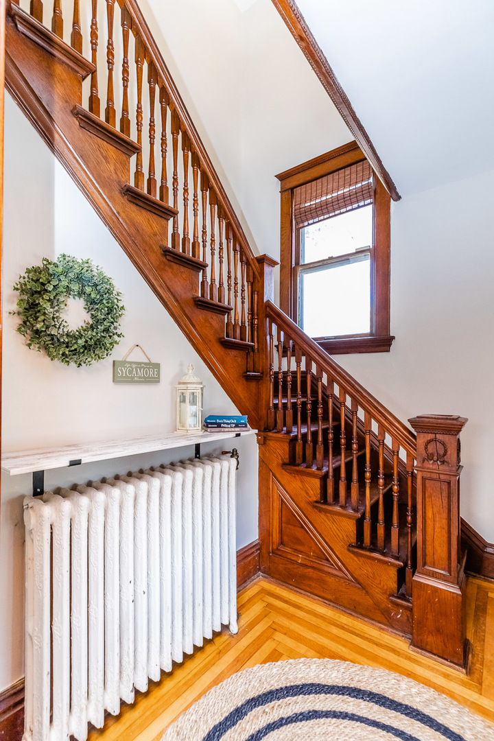 121 Mason Court Sycamore, IL 60178 - Photo 4 of 38 a view of staircase with lots of frames on wall and a window