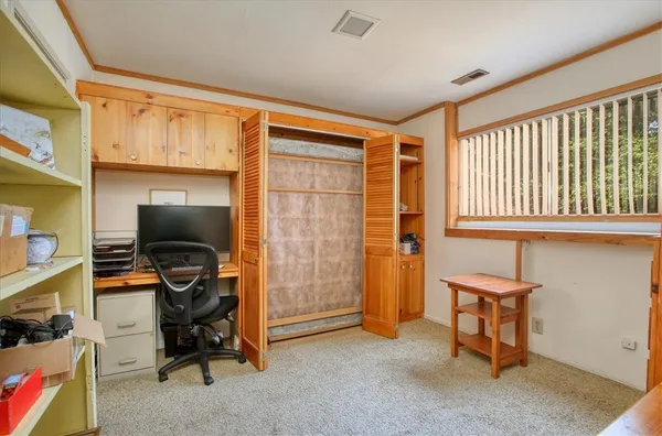 a view of room with workspace and windows