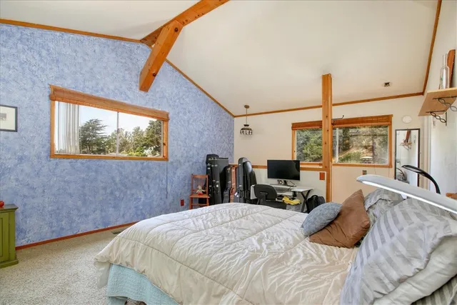 a bed room with a bed and a flat tv screen on the dresser