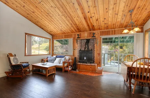a living room with furniture a table and wooden floor