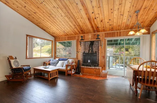 a living room with furniture a table and wooden floor