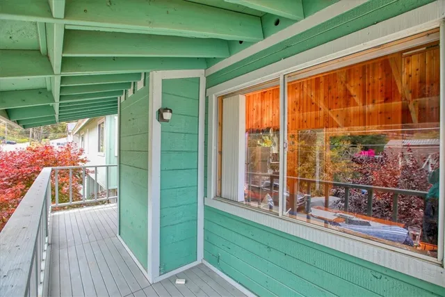 a view of a porch with wooden floor and outdoor space