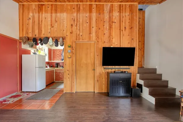 a view of a living room with furniture and a flat screen tv