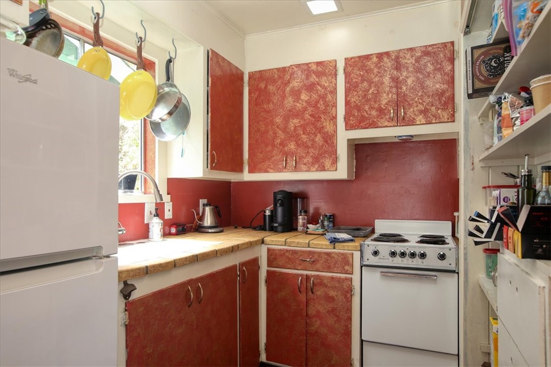 910 Sheffield Street Cambria, CA 93428 - Photo 9 of 29 a kitchen with stainless steel appliances a sink a stove and a refrigerator