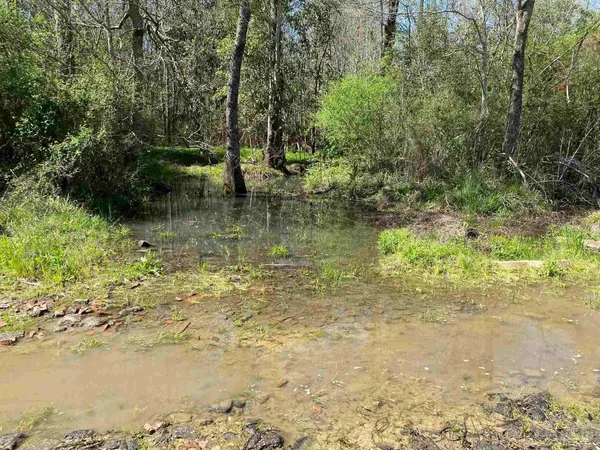 a view of a lake view with wooden fence