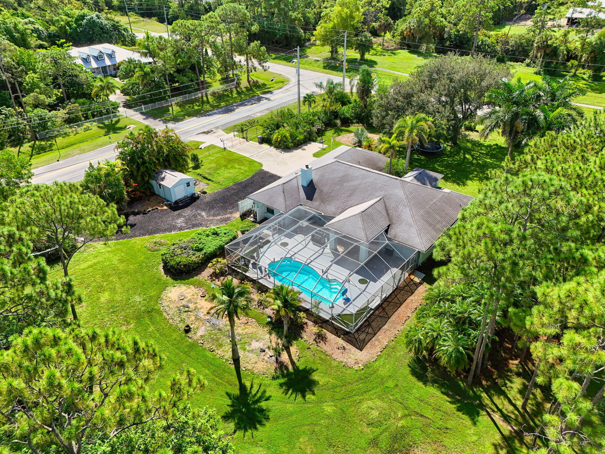 13033 160th Road North Jupiter, FL 33478 - Photo 2 of 79 an aerial view of a house with a garden and lake view