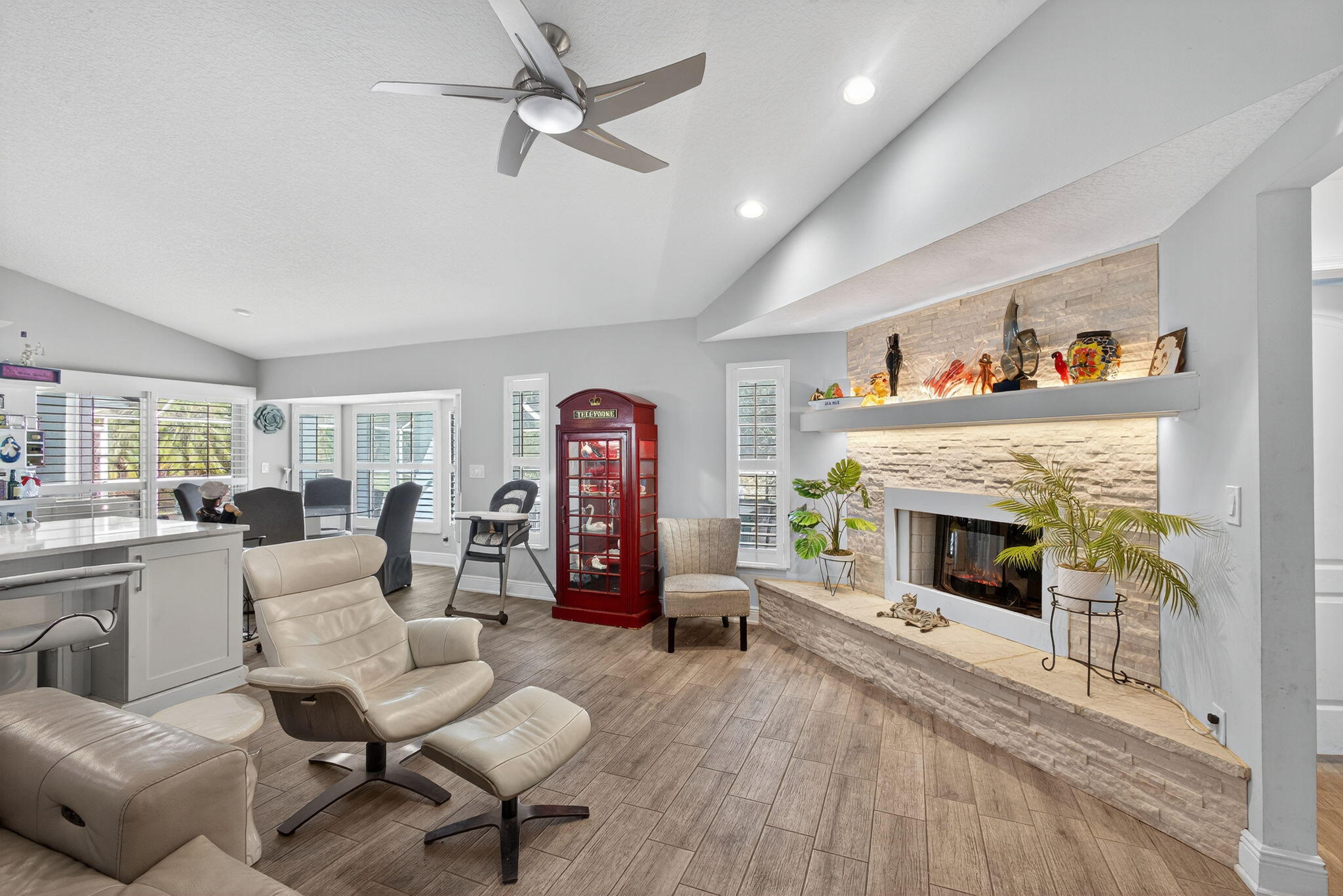 13033 160th Road North Jupiter, FL 33478 - Photo 28 of 79 a living room with furniture a fireplace and a large window