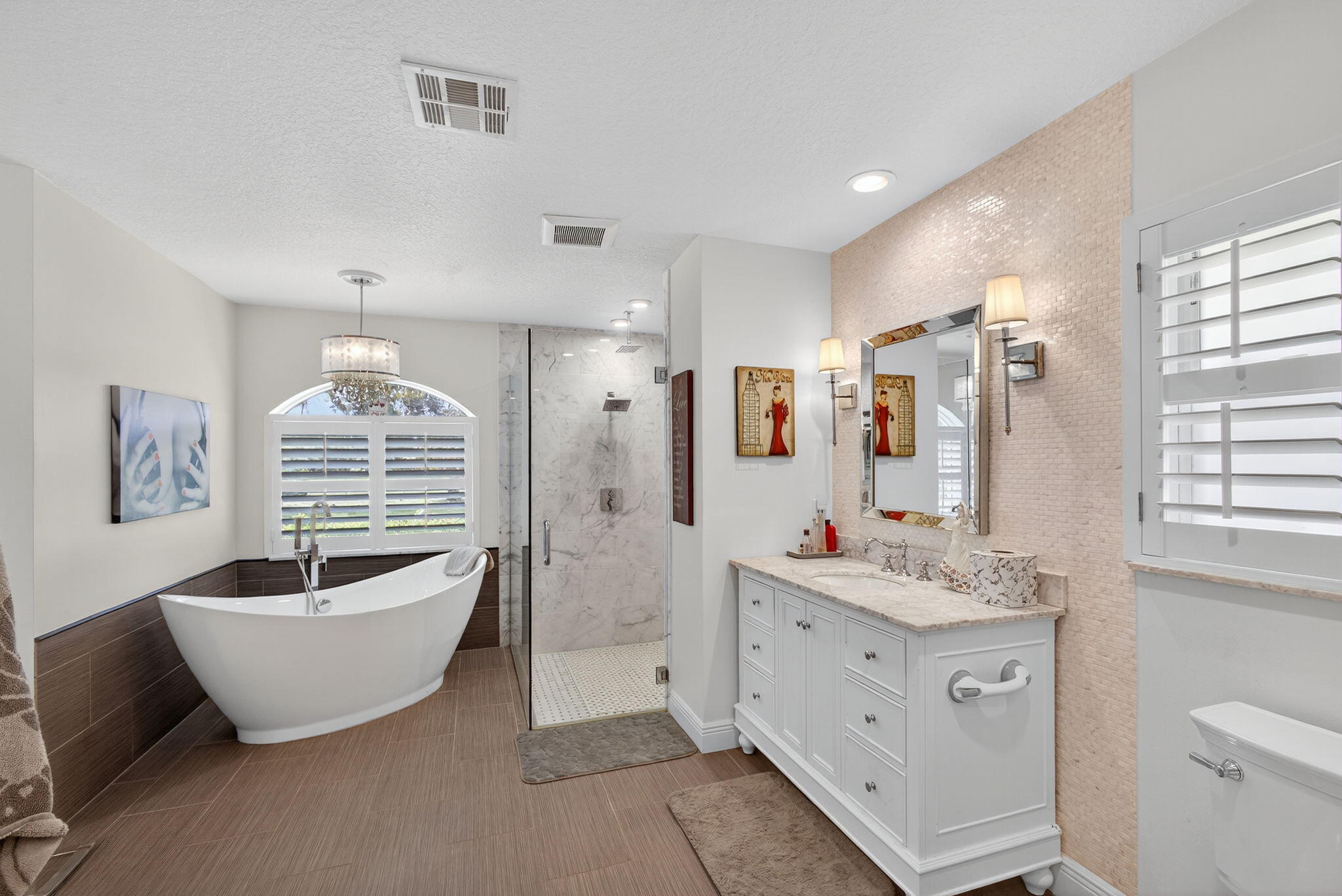 13033 160th Road North Jupiter, FL 33478 - Photo 31 of 79 a spacious bathroom with a double vanity sink a mirror a window and a bathtub