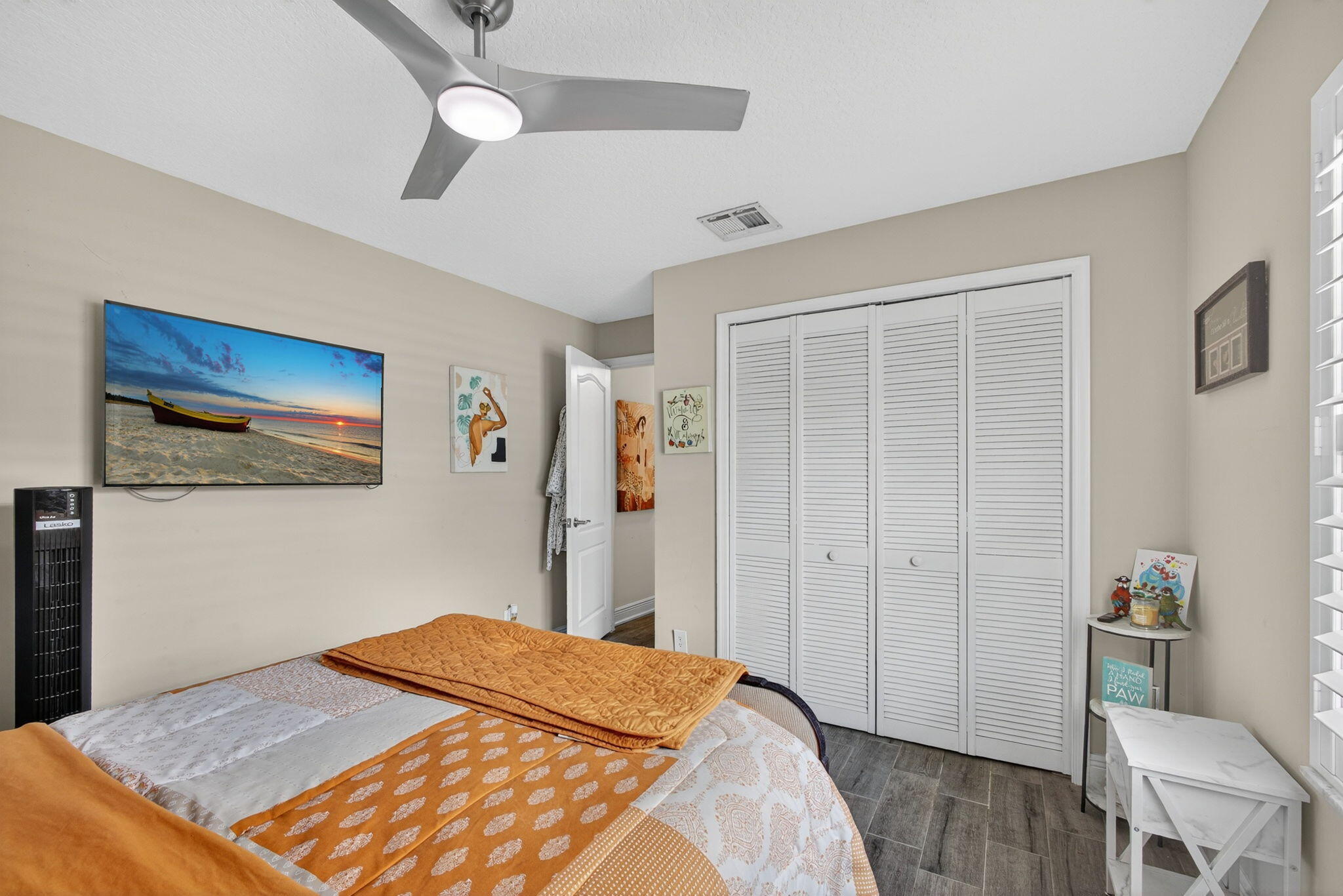 13033 160th Road North Jupiter, FL 33478 - Photo 35 of 79 a bedroom with a bed and a table in it