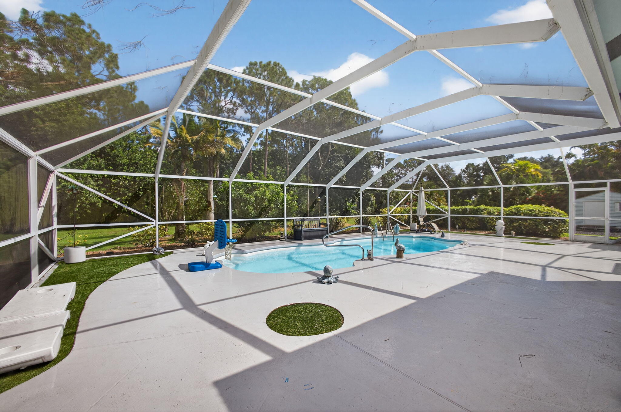 13033 160th Road North Jupiter, FL 33478 - Photo 42 of 79 a view of a swimming pool with a patio and a yard