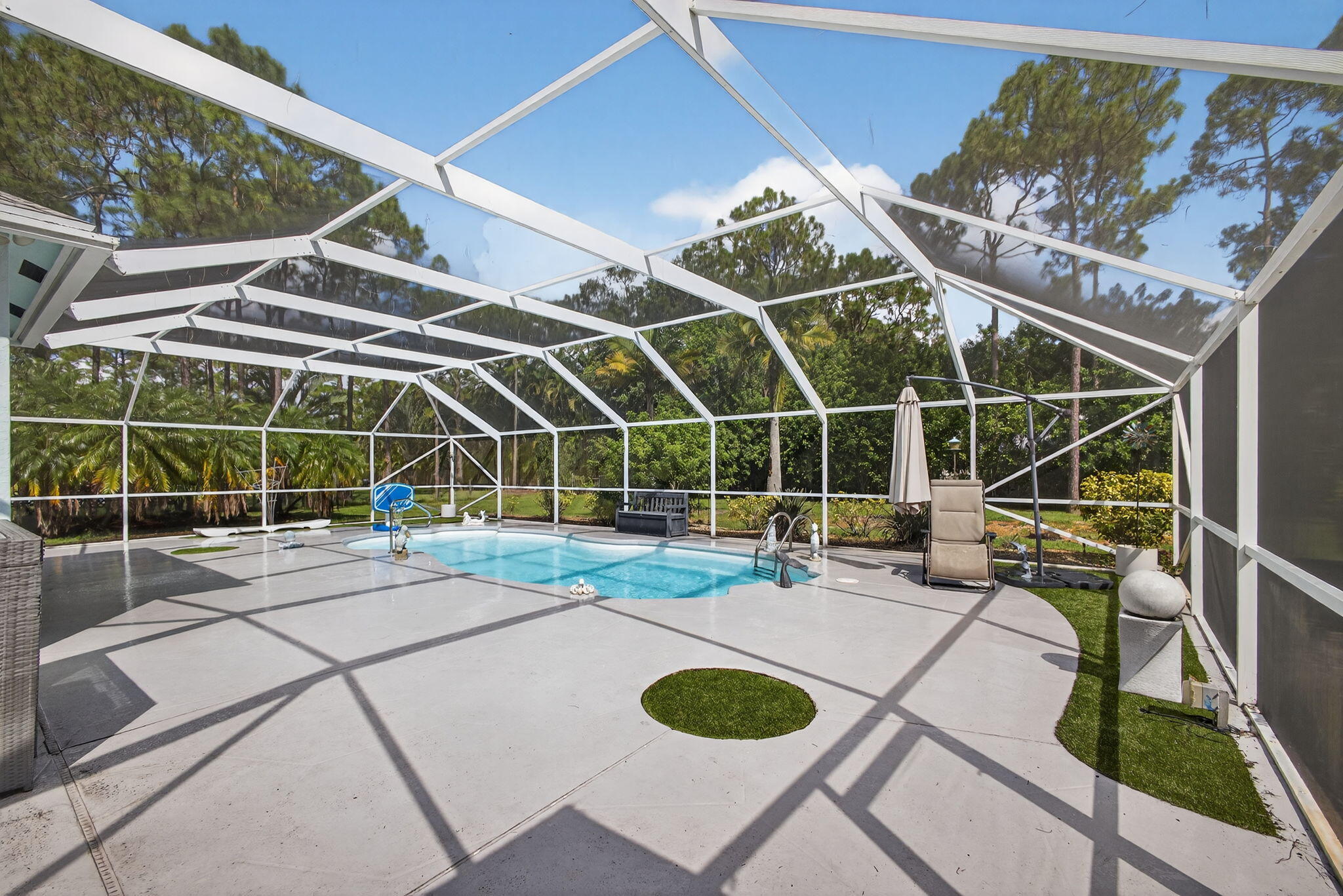 13033 160th Road North Jupiter, FL 33478 - Photo 43 of 79 a view of a swimming pool with outdoor seating and yard