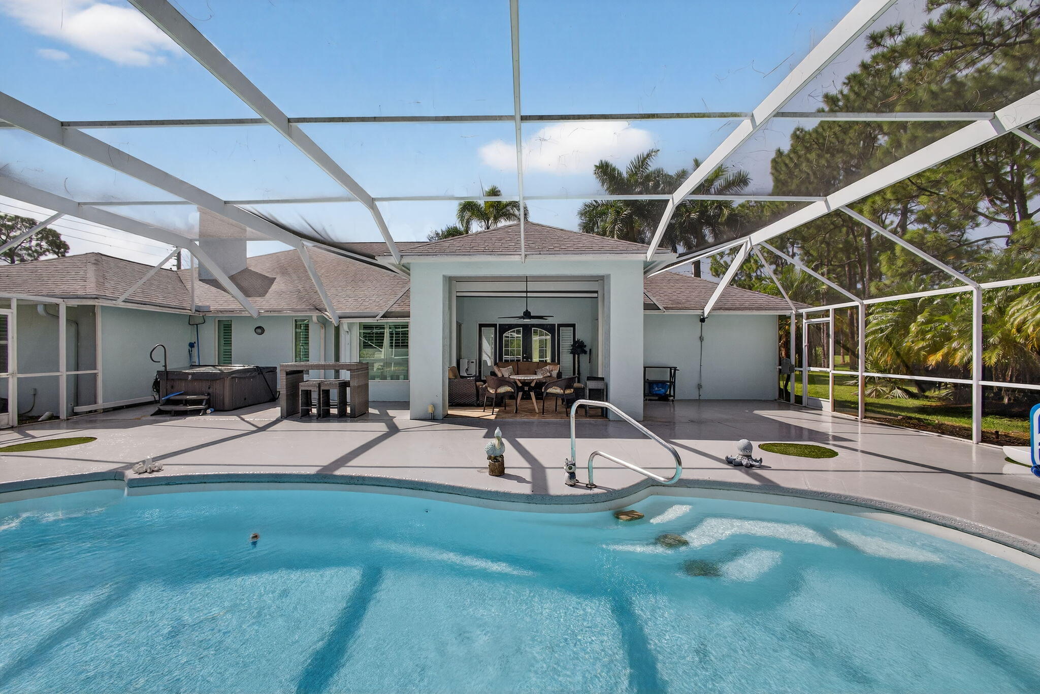 13033 160th Road North Jupiter, FL 33478 - Photo 47 of 79 a view of a backyard with table and chairs under an umbrella
