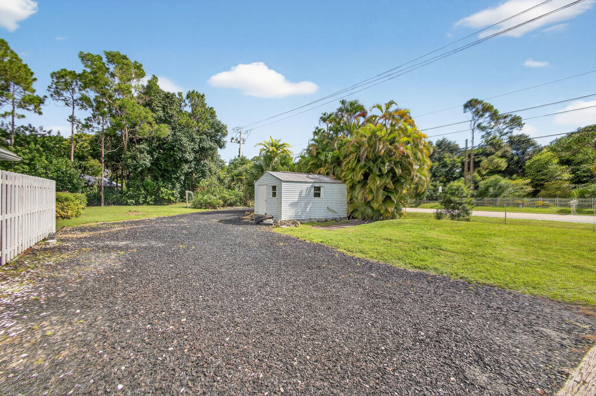 13033 160th Road North Jupiter, FL 33478 - Photo 61 of 79 a view of a house with a yard and a garage