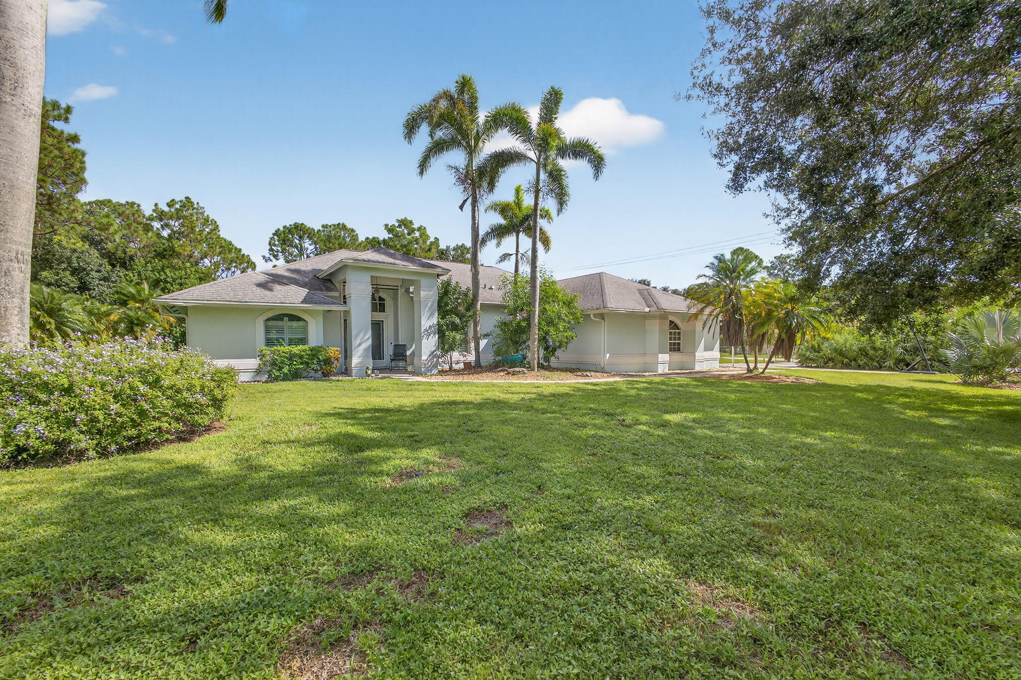13033 160th Road North Jupiter, FL 33478 - Photo 64 of 79 a front view of a house with a garden