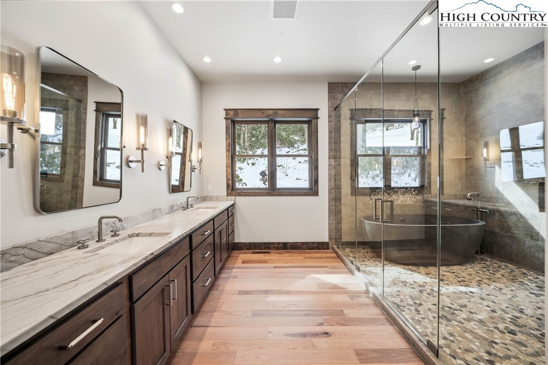 Lot 41 Mossy Creek Boone, NC 28607 - Photo 23 of 49 a spacious bathroom with a sink a large mirror and a bathtub