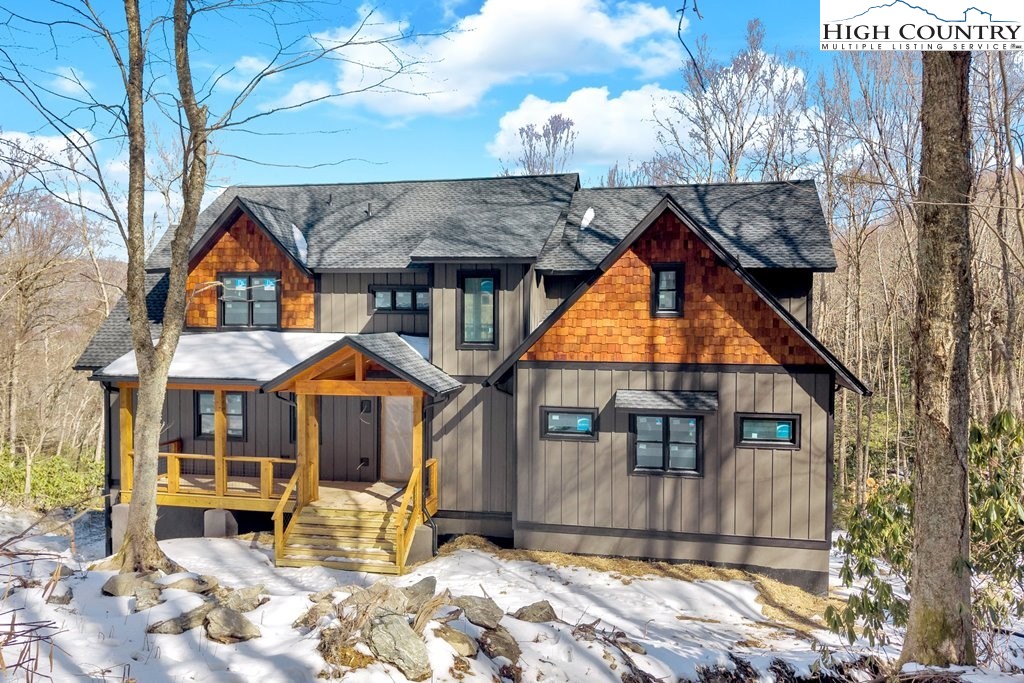 Lot 41 Mossy Creek Boone, NC 28607 - Photo 3 of 49 a front view of a house with a yard outdoor seating and covered with trees