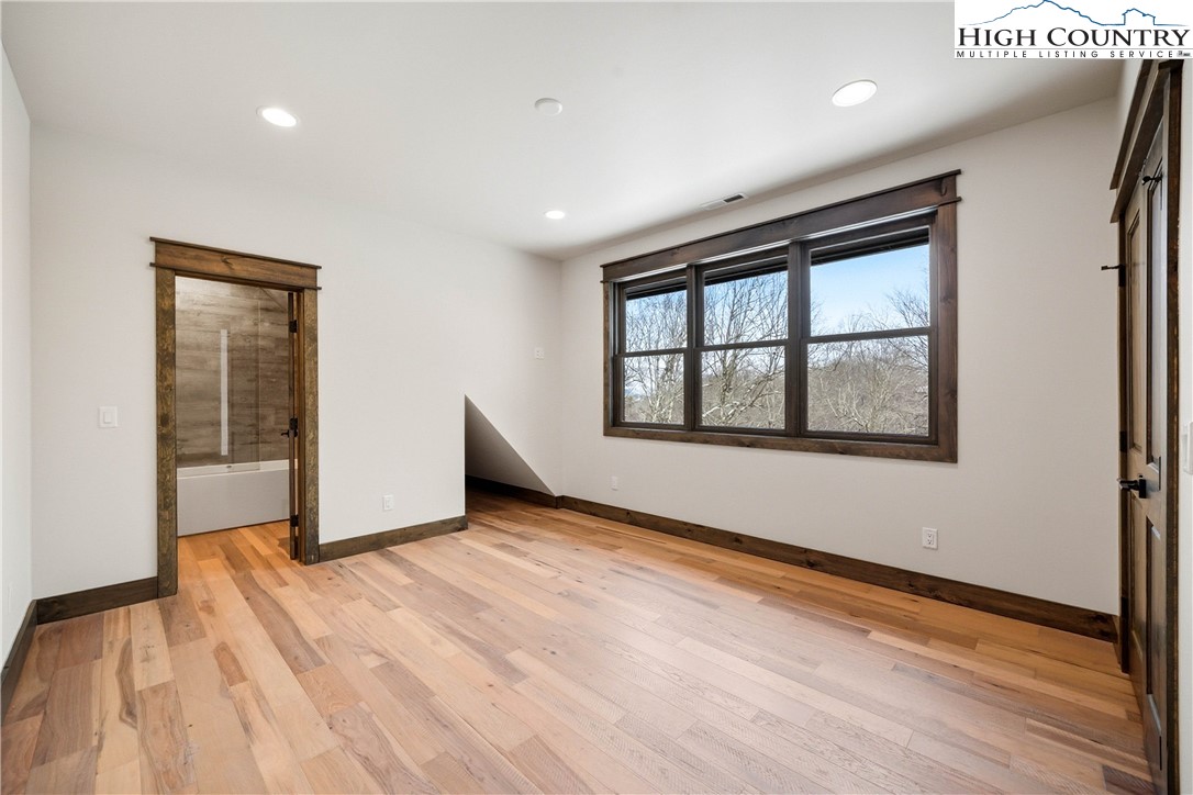 Lot 41 Mossy Creek Boone, NC 28607 - Photo 37 of 49 a view of an empty room with a window and wooden floor