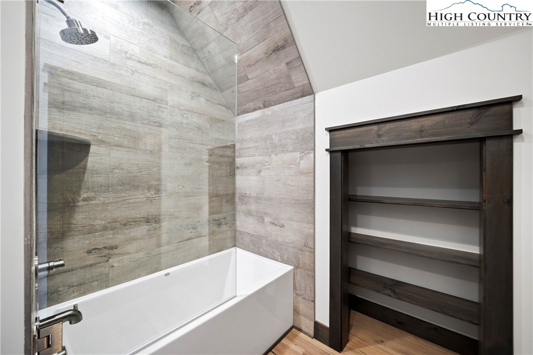 Lot 41 Mossy Creek Boone, NC 28607 - Photo 39 of 49 a bathroom with a bathtub and a shower