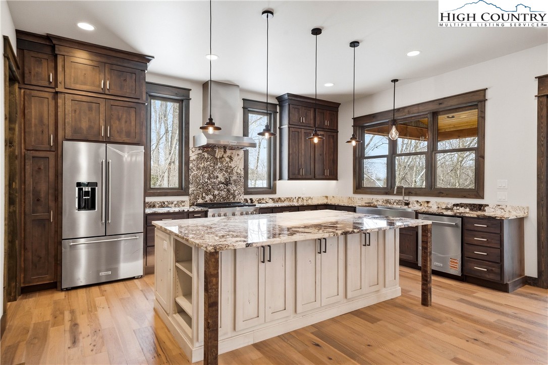 Lot 41 Mossy Creek Boone, NC 28607 - Photo 9 of 49 a kitchen with stainless steel appliances granite countertop a refrigerator a stove and a wooden floors
