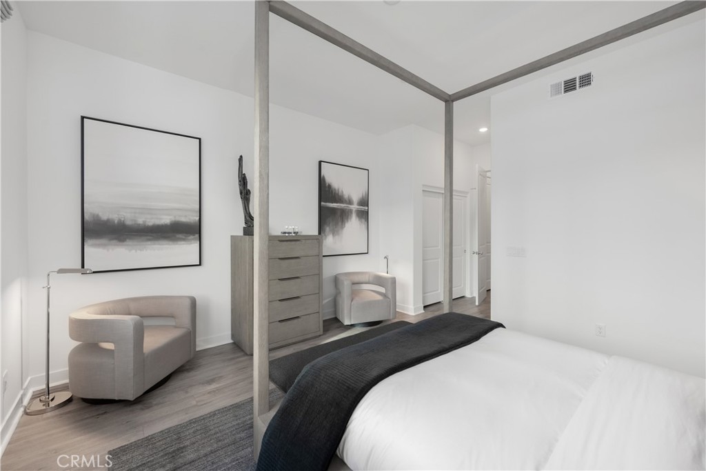 27225 Cranmore Way, Unit 101 Valencia, CA 91381 - Photo 11 of 36 a bedroom with a bed and a painting on the wall
