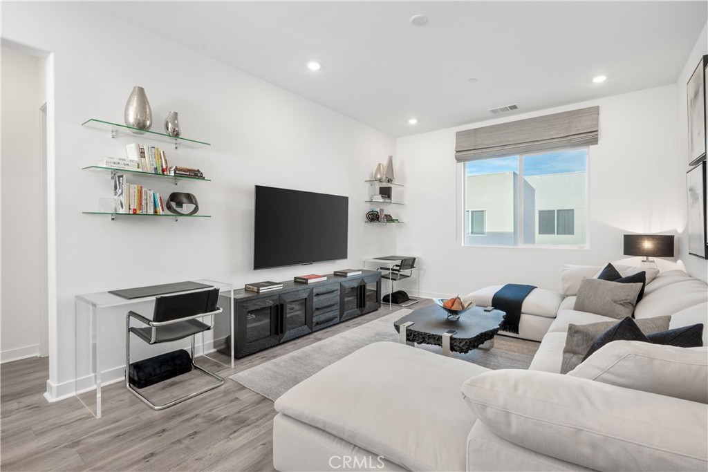 27225 Cranmore Way, Unit 101 Valencia, CA 91381 - Photo 15 of 36 a living room with furniture and a flat screen tv