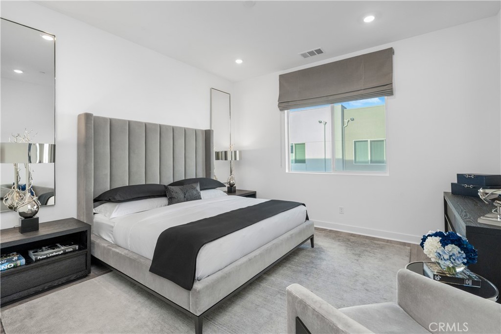 27225 Cranmore Way, Unit 101 Valencia, CA 91381 - Photo 16 of 36 a spacious bedroom with a bed and a dresser in it