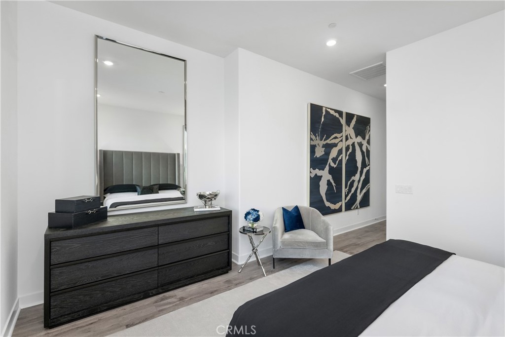 27225 Cranmore Way, Unit 101 Valencia, CA 91381 - Photo 17 of 36 a bedroom with a bed and a mirror