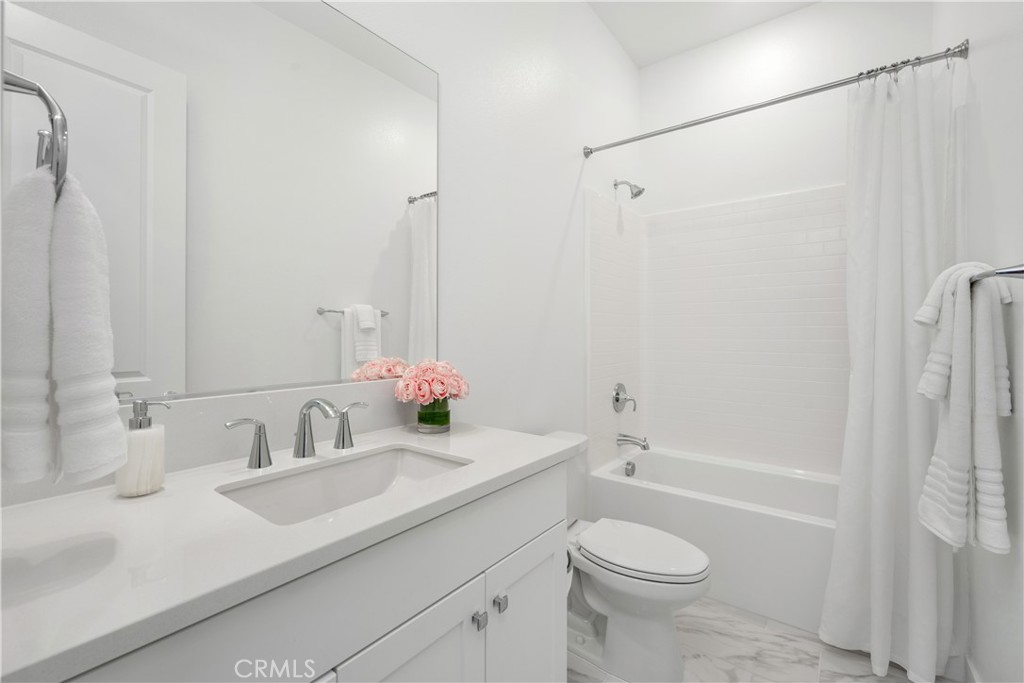 27225 Cranmore Way, Unit 101 Valencia, CA 91381 - Photo 20 of 36 a bathroom with a granite countertop sink toilet and shower