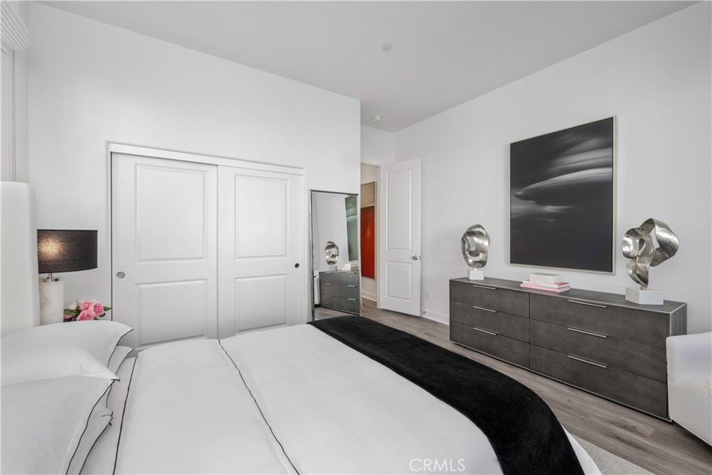 27225 Cranmore Way, Unit 101 Valencia, CA 91381 - Photo 23 of 36 a bedroom with a bed and a flat tv screen on dresser